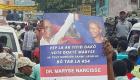 Haiti Election 2016 - Lavalas Supporter holding Maryse Narcisse poster with Aristide